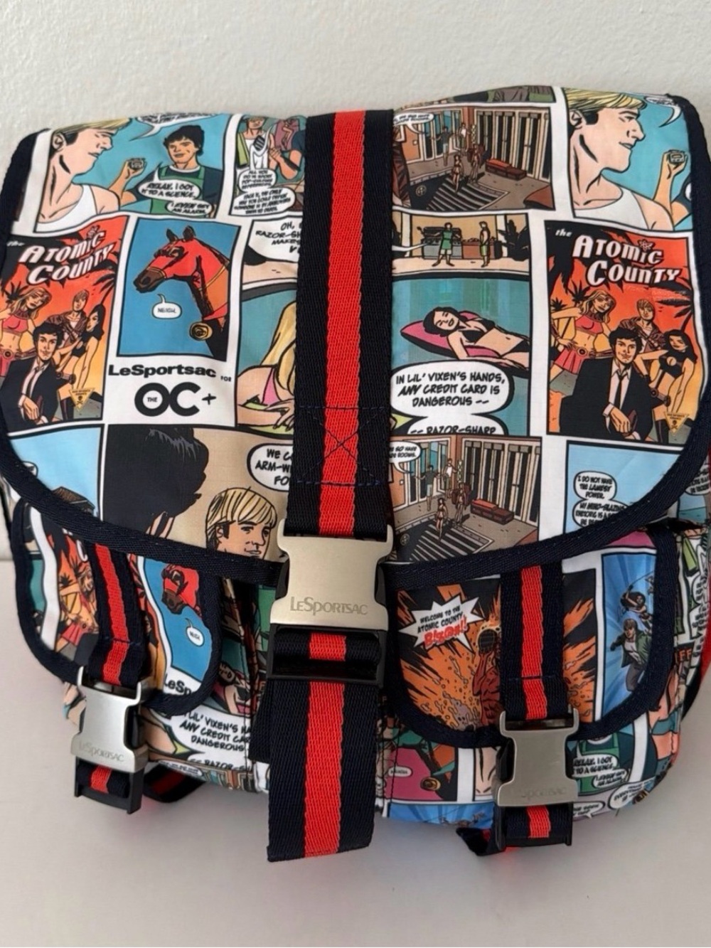 Lesportsac Messenger Bag in Multi-Color Comic Print with Navy & Red Straps